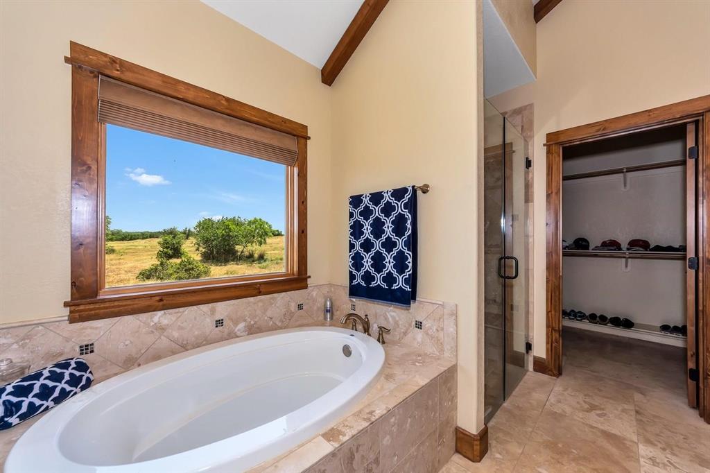 1231 Rawhide Ridge Graford, TX 76449 - Photo 21 of 26 Bathroom with independent shower and bath and lofted ceiling
