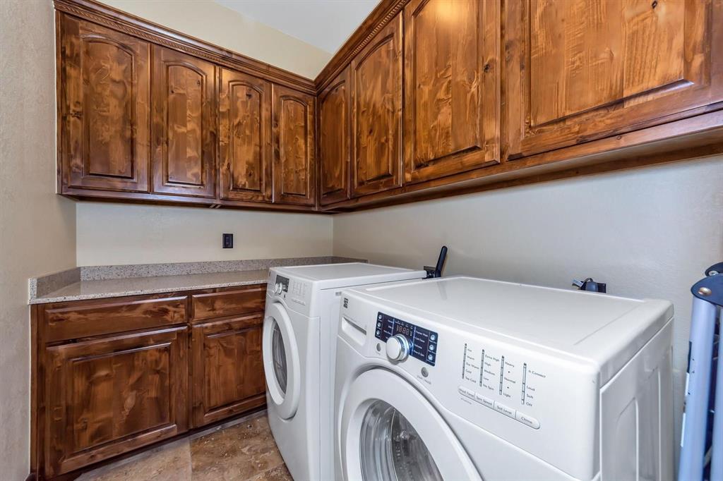 1231 Rawhide Ridge Graford, TX 76449 - Photo 26 of 26 Washroom featuring separate washer and dryer and cabinets