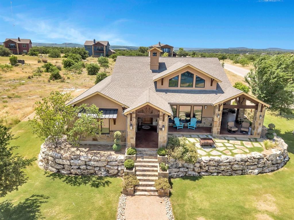 1231 Rawhide Ridge Graford, TX 76449 - Photo 4 of 26 View of front of house featuring a patio area, a fireplace, and a front yard