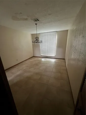 a view of a livingroom with wooden floor and a ceiling fan