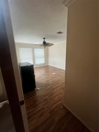 a view of a room with wooden floor
