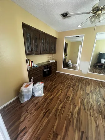 a view of a room with a window and wooden floor