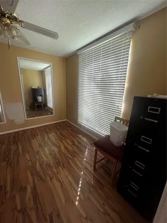 a room with wooden floor and furniture