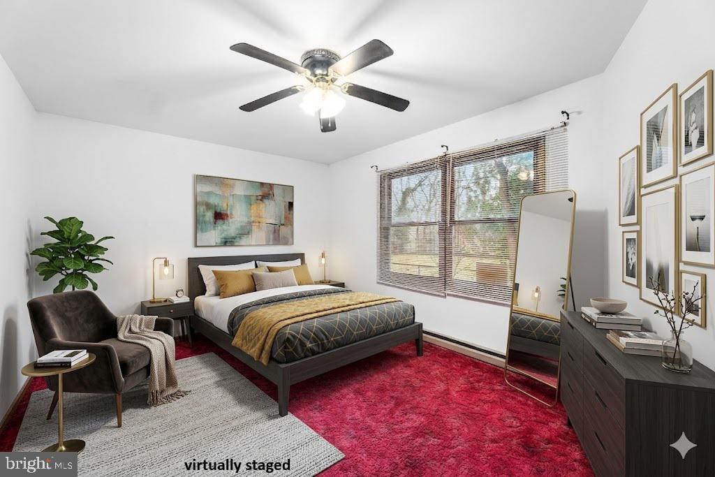 139 Prospect Street Chestertown, MD 21620 - Photo 13 of 28 a spacious bedroom with a bed a chandelier and a window
