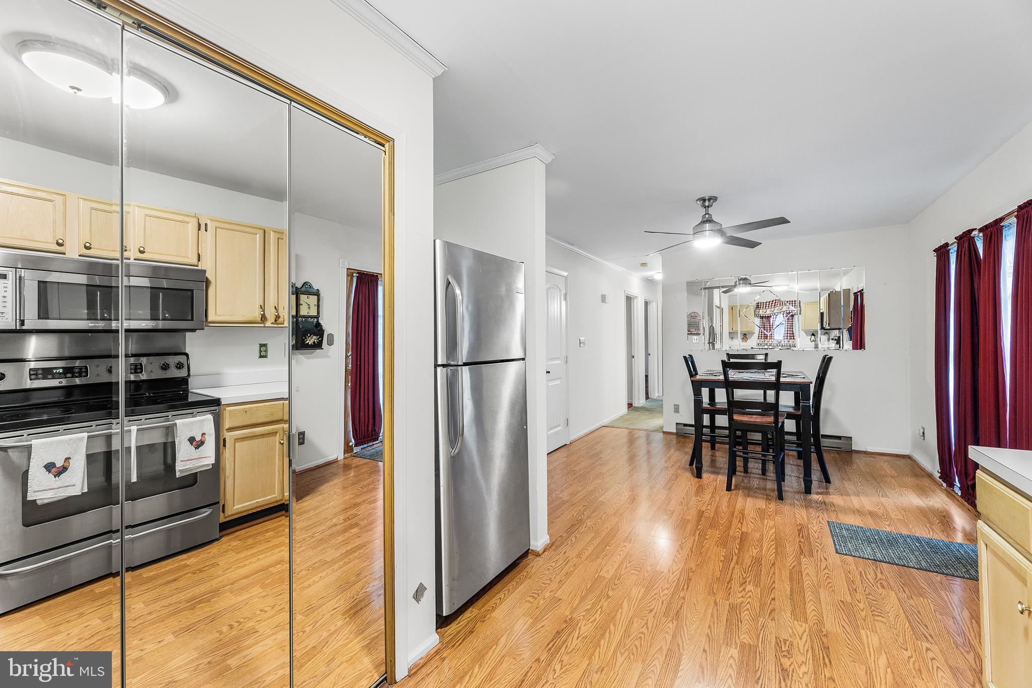 139 Prospect Street Chestertown, MD 21620 - Photo 10 of 28 a kitchen with stainless steel appliances a dining table chairs and wooden floor