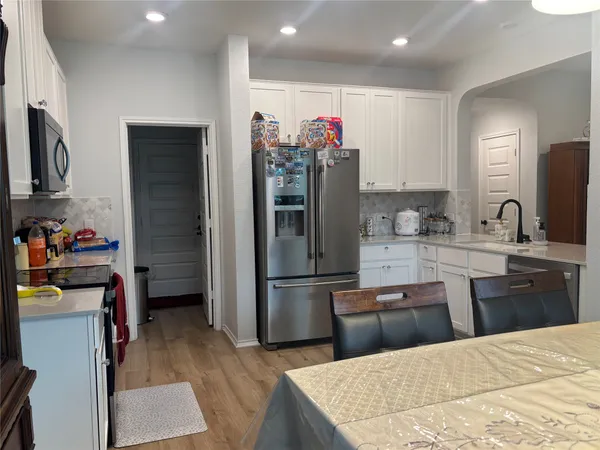 a kitchen with a refrigerator and a sink