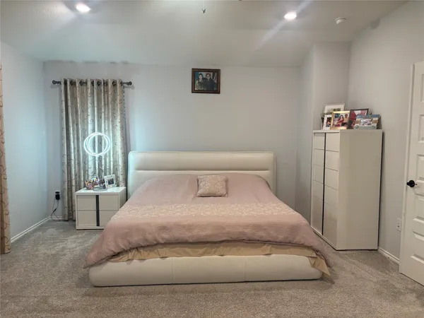 a large white bed in a white room