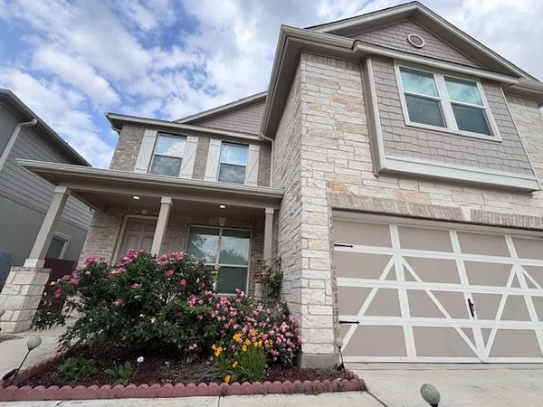a front view of a house with a garden