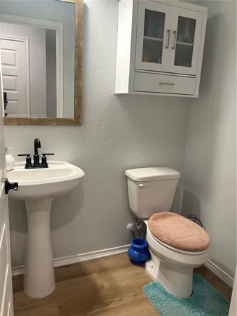 a bathroom with a sink toilet and a mirror