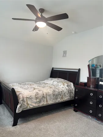 a bedroom with a bed and a night stand
