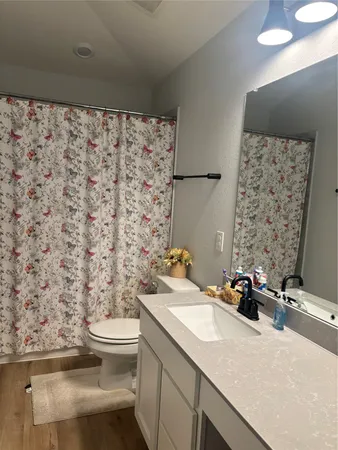 a bathroom with a sink toilet and shower
