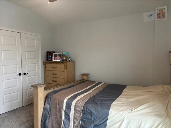 a bedroom with a bed and a closet