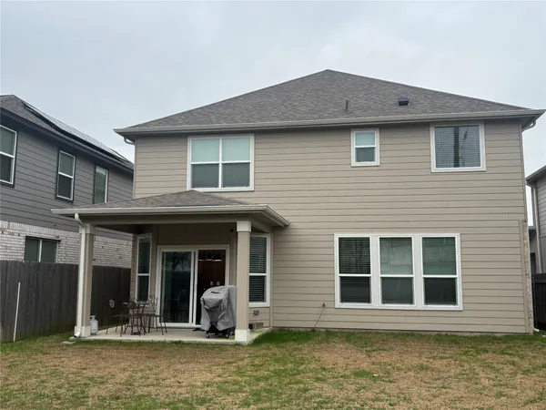 a front view of a house with a lots of windows and plants