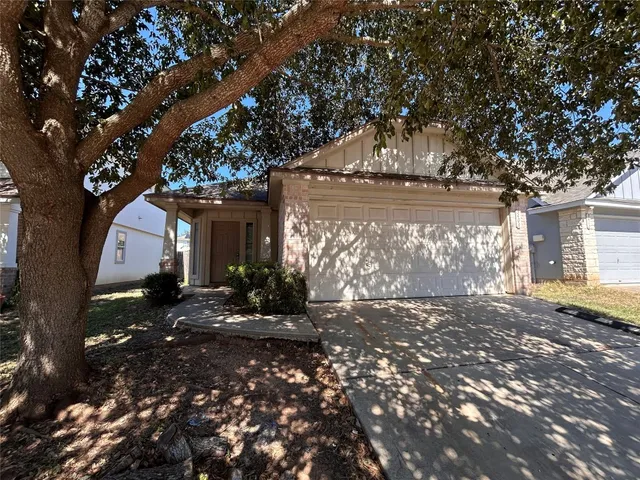 a view of a house with a tree