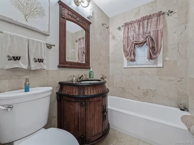 a bathroom with a toilet a sink and bathtub