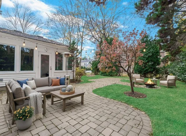a backyard of a house with table and chairs