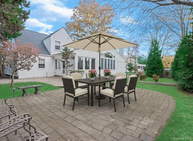 a view of a house with backyard and a sitting area