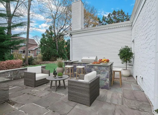 a balcony with furniture and a potted plant