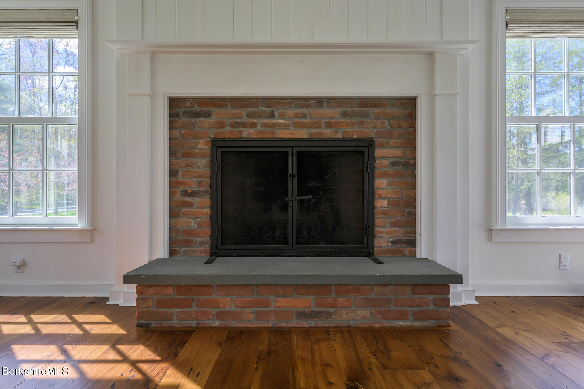 304 Hickey Hill Road Sheffield, MA 01257 - Photo 29 of 60 a living room with a fireplace and a table