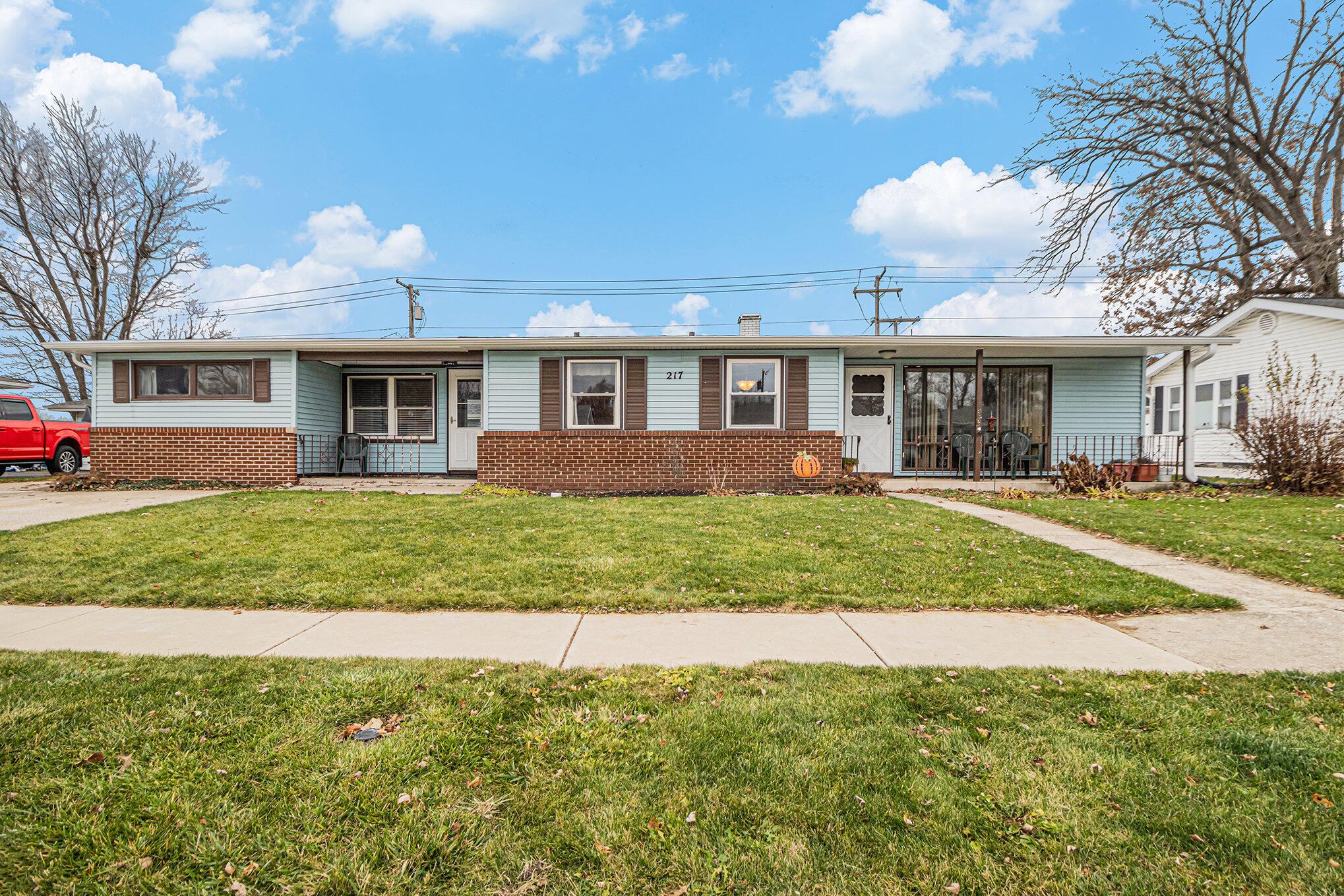 a front view of house with yard and green space
