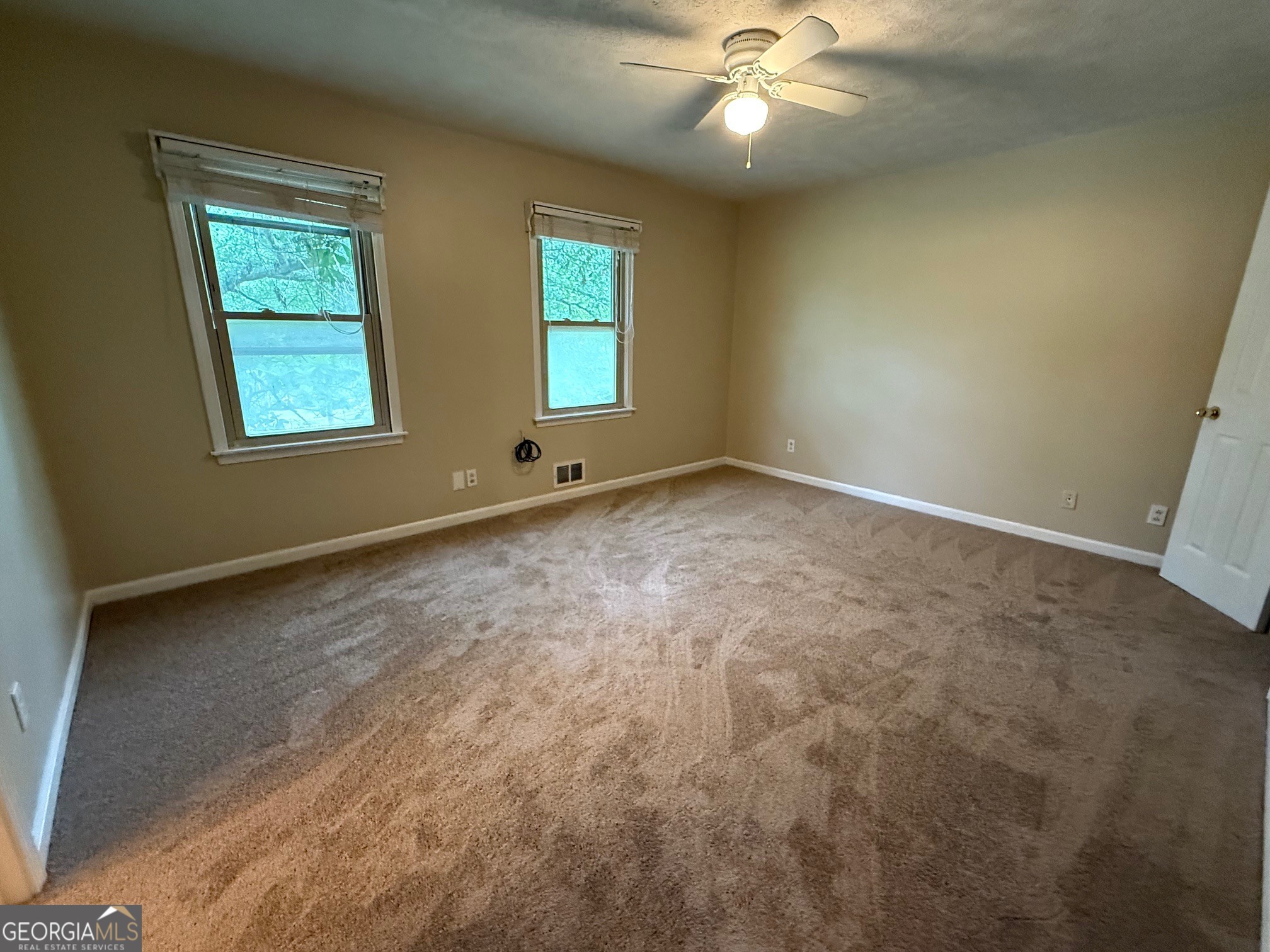 2691 Falcon Ridge Drive Southwest Grayson, GA 30017 - Photo 5 of 10 an empty room with windows and fan