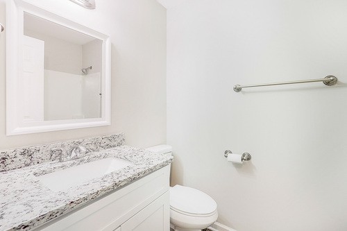 879 Heritage Circle Madison, TN 37115 - Photo 13 of 27 a bathroom with a granite countertop sink a toilet and shower