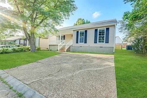 879 Heritage Circle Madison, TN 37115 - Photo 2 of 27 a front view of a house with garden and porch