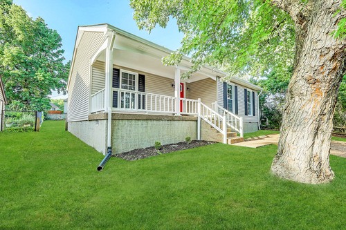 879 Heritage Circle Madison, TN 37115 - Photo 3 of 27 a white house that has a small yard and large trees