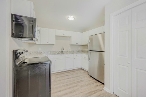 879 Heritage Circle Madison, TN 37115 - Photo 8 of 27 a kitchen with a refrigerator sink and cabinets