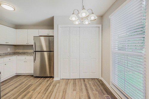 879 Heritage Circle Madison, TN 37115 - Photo 9 of 27 a view of kitchen with refrigerator cabinets and wooden floor
