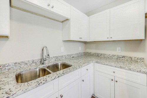 879 Heritage Circle Madison, TN 37115 - Photo 10 of 27 a kitchen with granite countertop a sink and cabinets