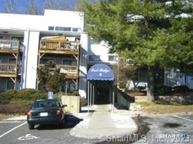 5 Nabby Road, Unit A51 Danbury, CT 06811 - Photo 1 of 13 a car parked in front of a building