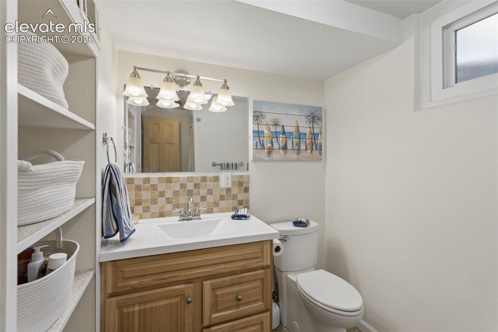 4004 Mallow Road Colorado Springs, CO 80907 - Photo 37 of 50 Wood-finish vanity with a white countertop and integrated sink