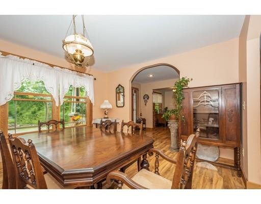 389 Turnpike Road Ashby, MA 01431 - Photo 15 of 30 a living room with dining table and a large window