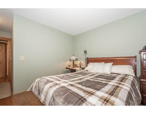 389 Turnpike Road Ashby, MA 01431 - Photo 21 of 30 a bedroom with a bed and a lamp