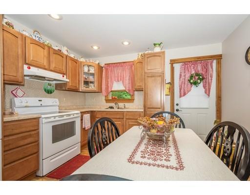 389 Turnpike Road Ashby, MA 01431 - Photo 25 of 30 a kitchen with stainless steel appliances granite countertop a stove a sink dishwasher and a microwave oven with white cabinets