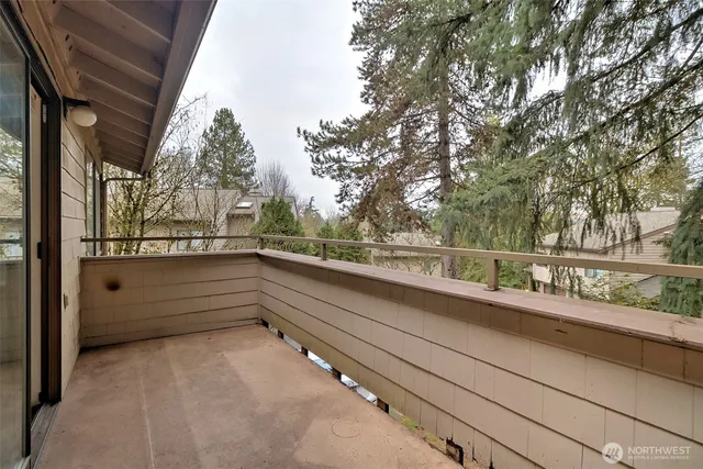 a view of balcony with two trees and a outdoor space