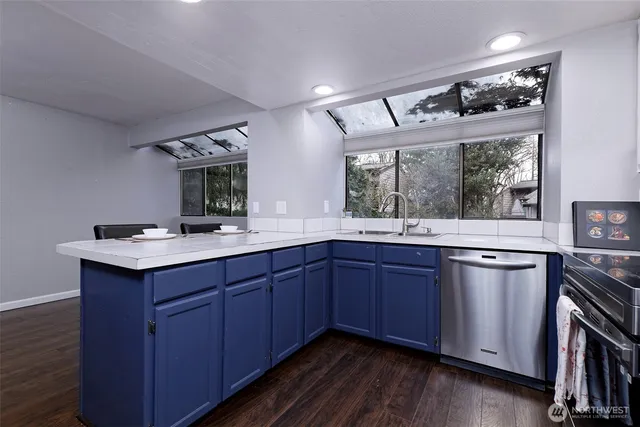 a kitchen with a sink and wooden cabinets