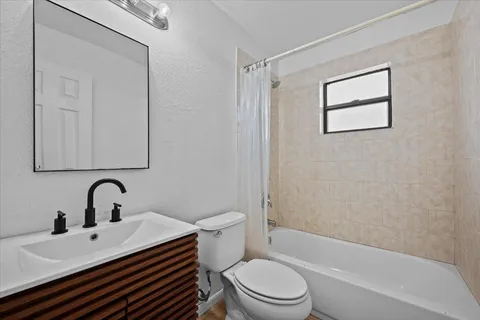a bathroom with a sink toilet a mirror and shower