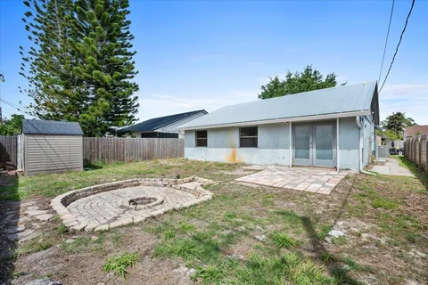 a backyard of a house with table and chairs