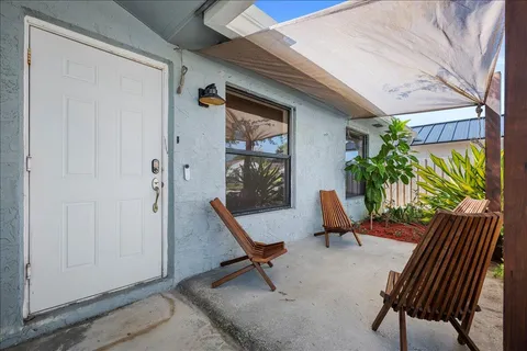 a view of a chairs and table in a porch