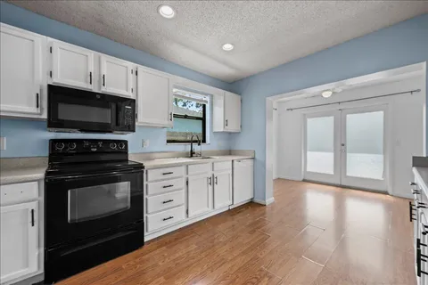 a kitchen with stainless steel appliances a stove a sink and a microwave