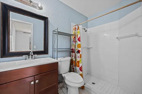a bathroom with a sink toilet and shower