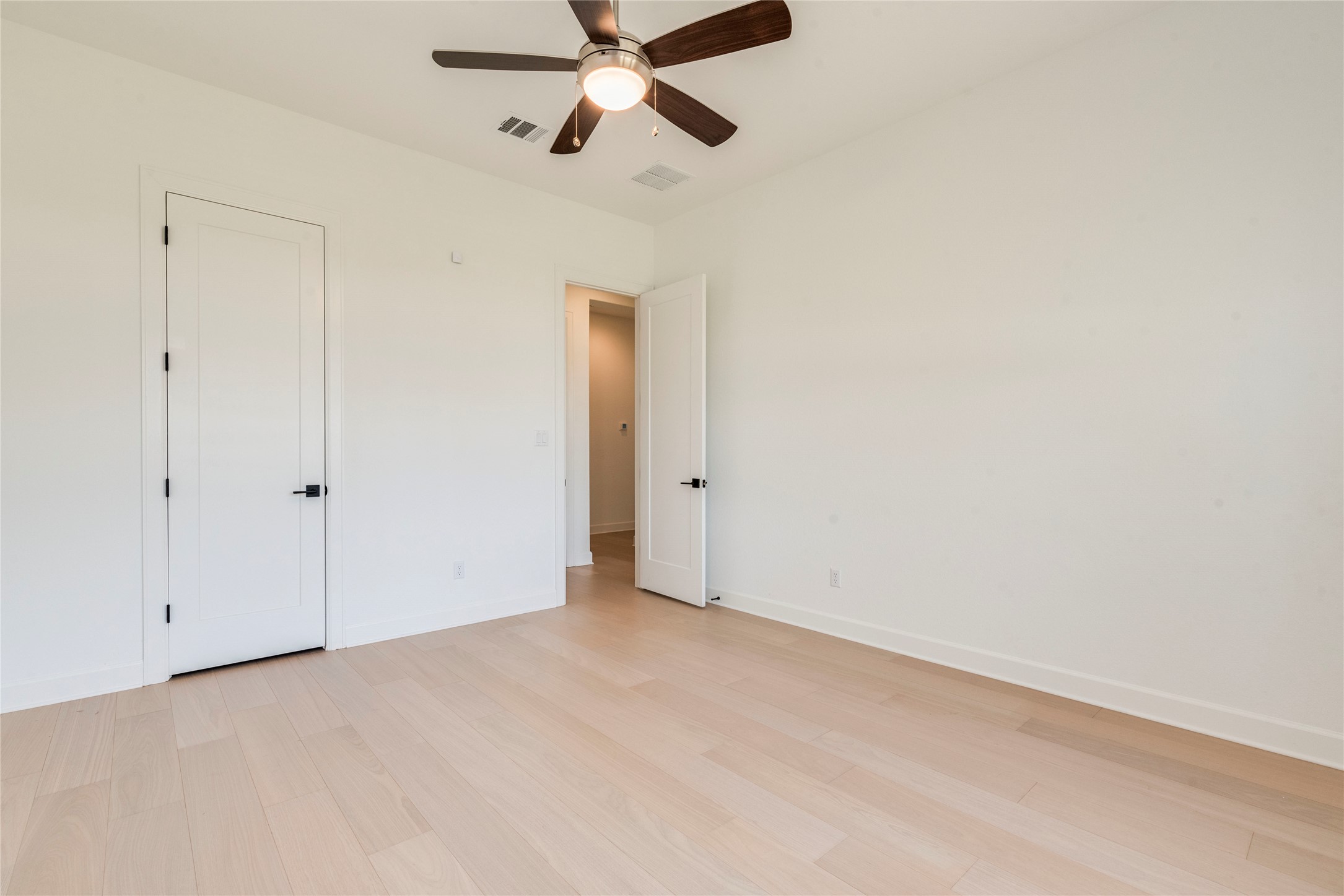 231 Call Drive Austin, TX 78737 - Photo 23 of 40 Unfurnished bedroom featuring light wood-style flooring and a ceiling fan