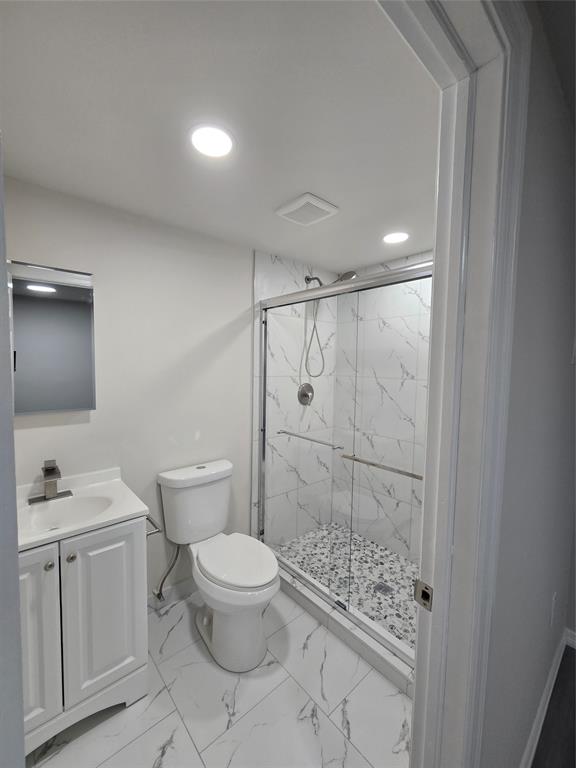 11854 Cove Place Boca Raton, FL 33428 - Photo 3 of 7 a bathroom with a granite countertop sink a toilet and shower