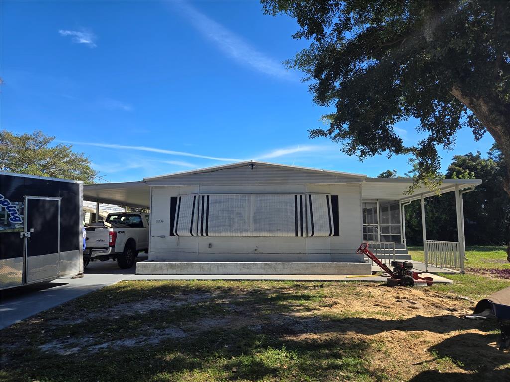 11854 Cove Place Boca Raton, FL 33428 - Photo 6 of 7 a view of a house with backyard porch and sitting area