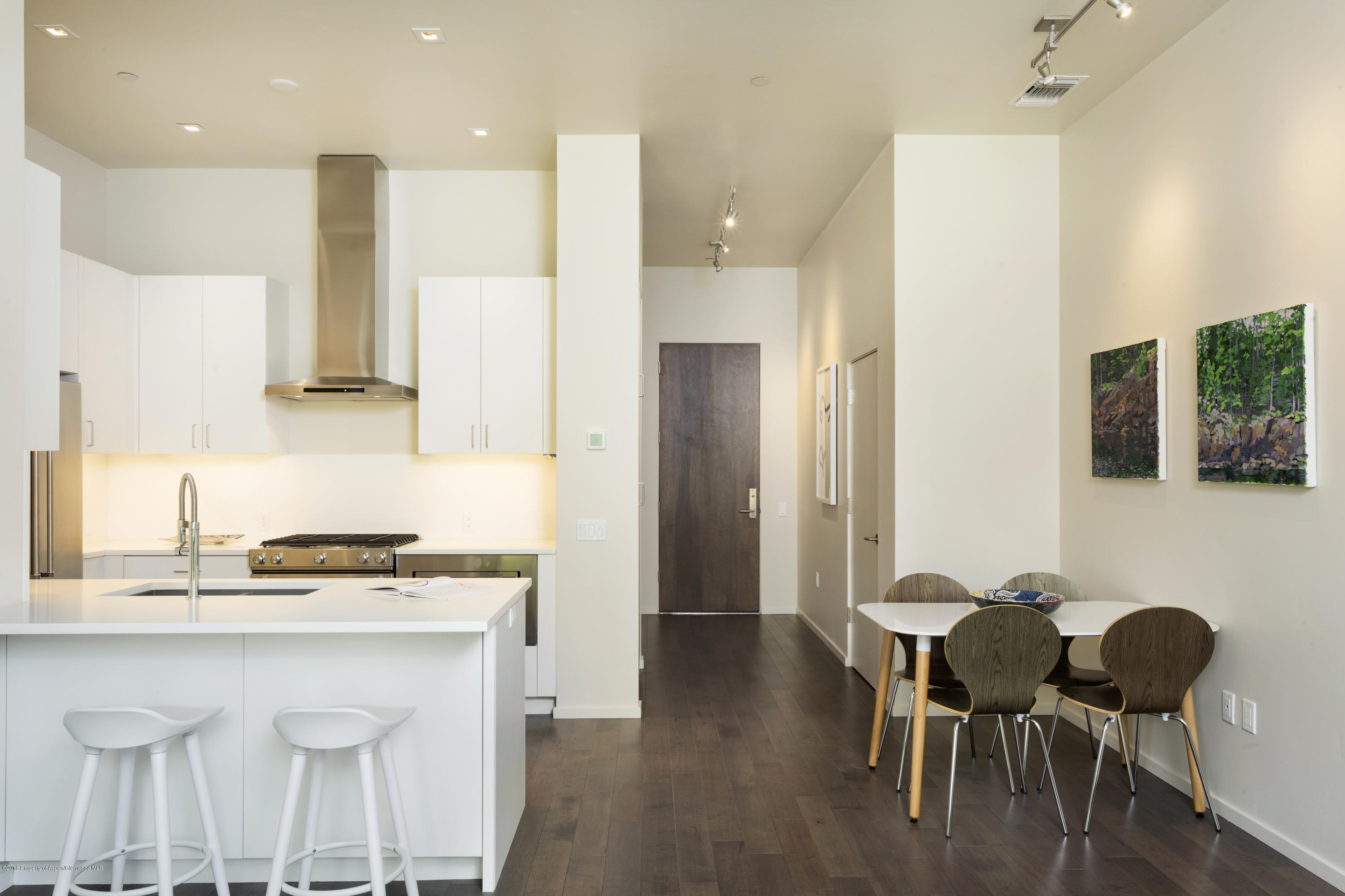 100 Evans Road, Unit 203 Basalt, CO 81621 - Photo 6 of 24 a kitchen with stainless steel appliances granite countertop a table chairs refrigerator and sink