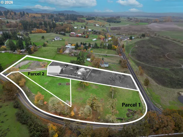 an aerial view of a house with yard