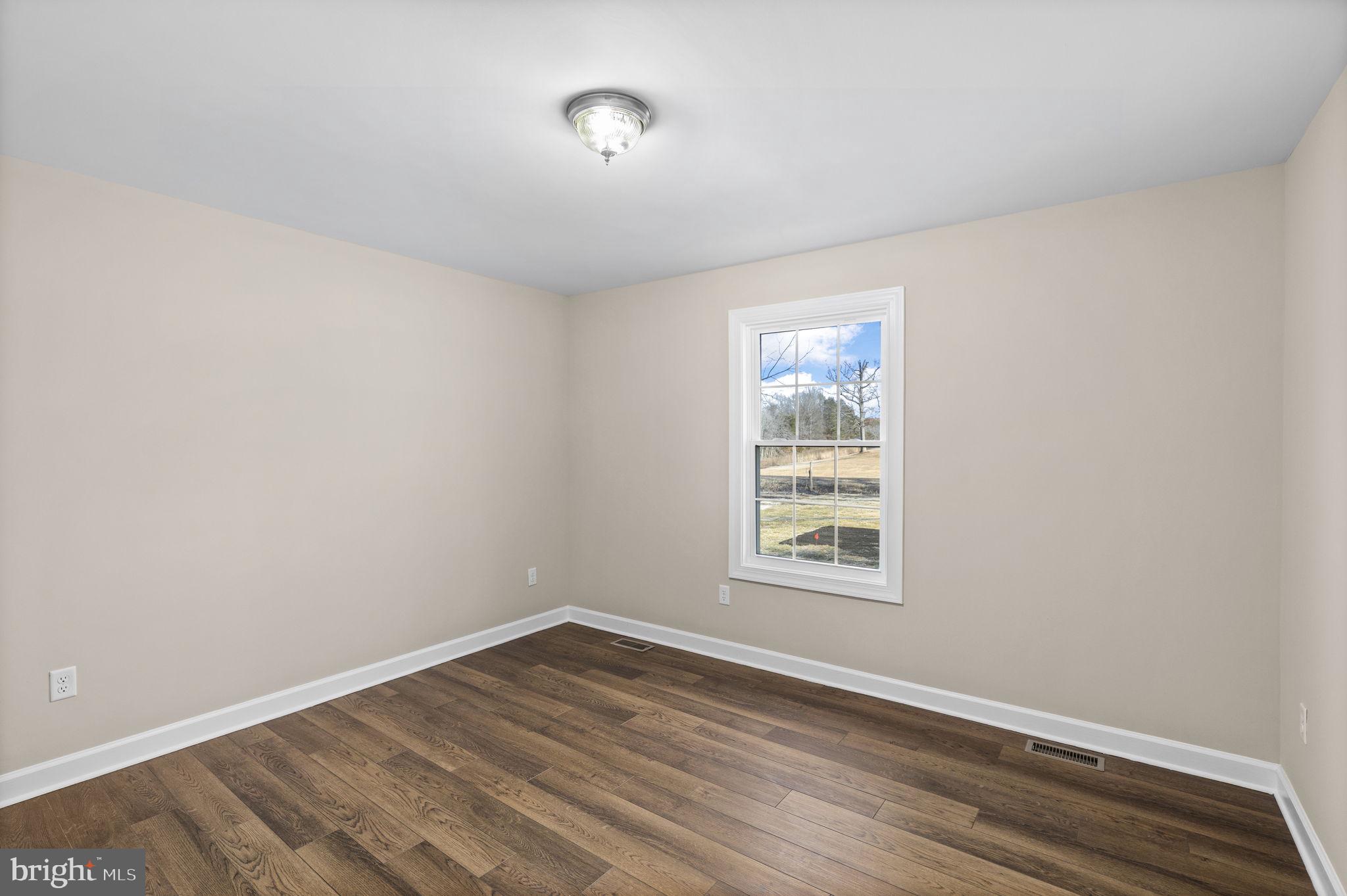 18078 Monrovia Road Orange, VA 22960 - Photo 13 of 49 an empty room with wooden floor and windows