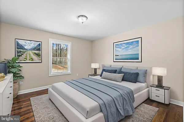 a bedroom with a large bed and a window